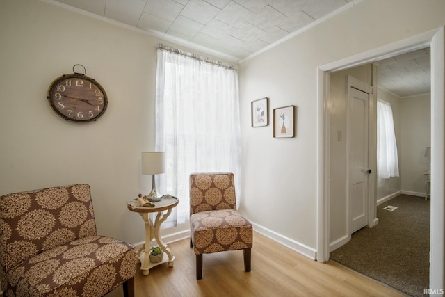 701 E N St, Kokomo, IN 46901 - sitting room with ornamental molding and light wood-style flooring