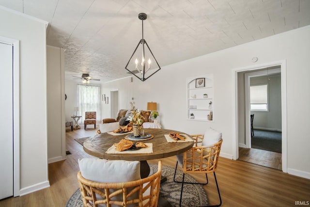 701 E N St, Kokomo, IN 46901 - dining room with healthy amount of natural light, a chandelier, wood finished floors, crown molding, and ceiling fan