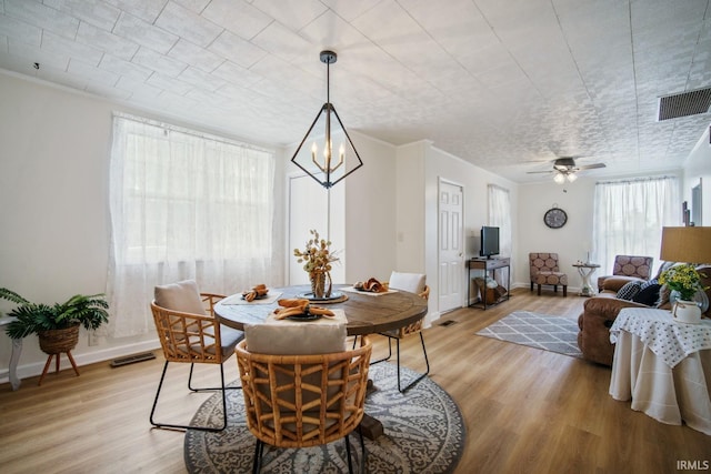 701 E N St, Kokomo, IN 46901 - dining area with light wood-type flooring, a chandelier, and a ceiling fan