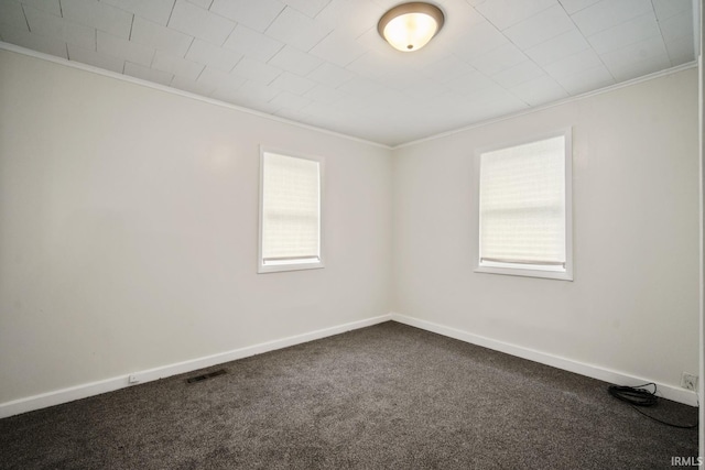 701 E N St, Kokomo, IN 46901 - spare room with crown molding, healthy amount of natural light, and dark carpet
