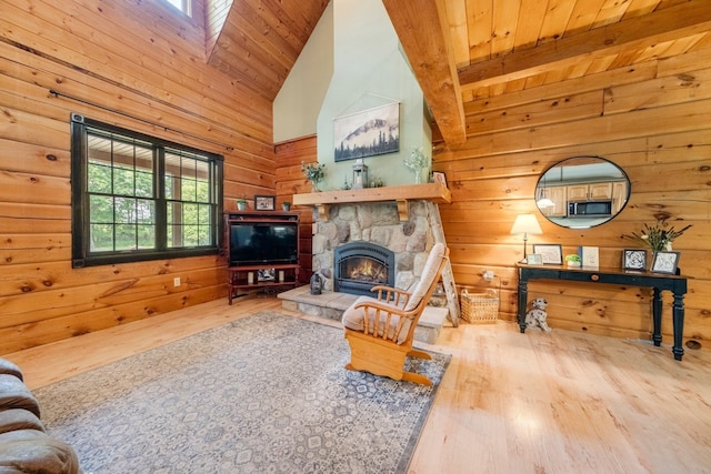 5618 N 725 E, Fremont, IN 46737 - living room with wood finished floors, wood ceiling, wood walls, a stone fireplace, and high vaulted ceiling