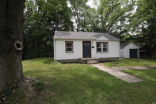 651 W Maple St, Wabash, IN 46992 - bungalow with a garage, a front yard, an outdoor structure, and roof with shingles