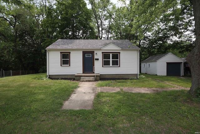 651 W Maple St, Wabash, IN 46992 - view of front of house featuring a detached garage, an outdoor structure, and roof with shingles