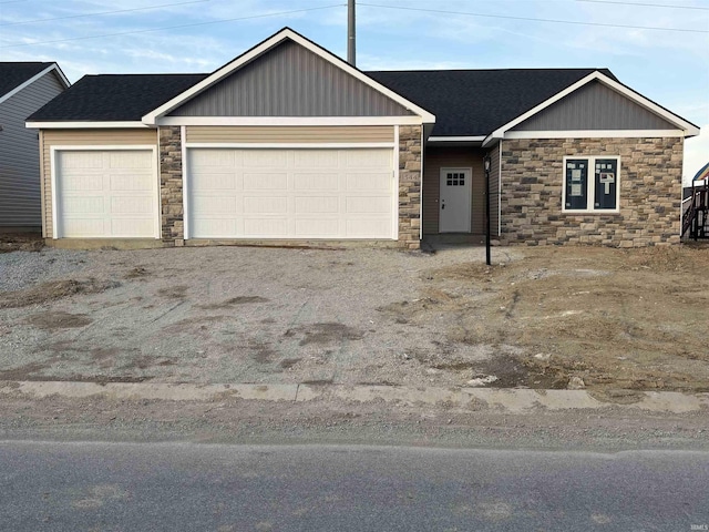 1544 Cananea Way, Fort Wayne, IN 46845 - view of front of home with stone siding, a garage, asphalt driveway, and board and batten siding