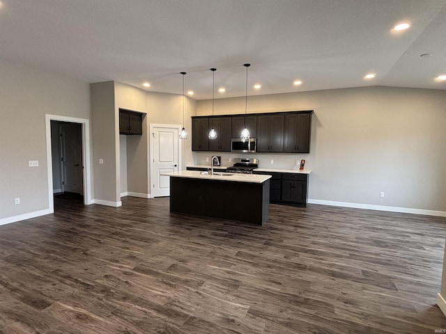 1544 Cananea Way, Fort Wayne, IN 46845 - kitchen featuring appliances with stainless steel finishes, dark wood finished floors, an island with sink, open floor plan, and light countertops