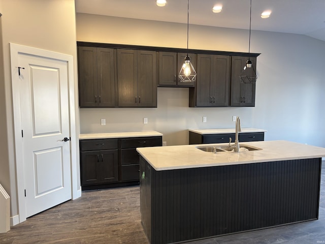 1544 Cananea Way, Fort Wayne, IN 46845 - kitchen with dark wood finished floors, dark brown cabinetry, hanging light fixtures, a center island with sink, and light countertops