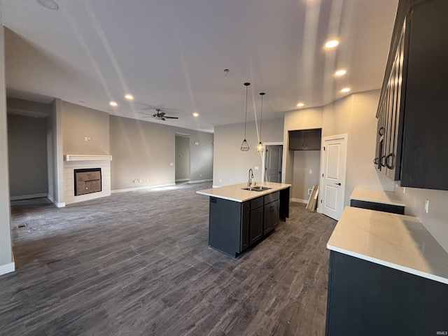 1544 Cananea Way, Fort Wayne, IN 46845 - kitchen featuring a ceiling fan, light countertops, a tile fireplace, open floor plan, and dark wood finished floors