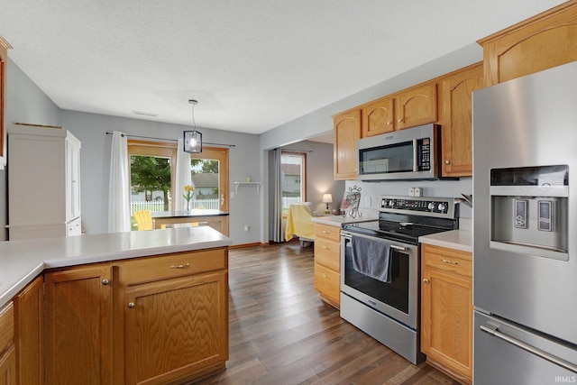 9536 Ballymore Dr, Fort Wayne, IN 46835 - kitchen featuring stainless steel appliances, dark wood-type flooring, light countertops, and decorative light fixtures