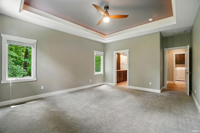 126 Tumbling Stone Ct, Fort Wayne, IN 46845 - unfurnished bedroom with a tray ceiling, washer / clothes dryer, carpet floors, ensuite bathroom, and ceiling fan