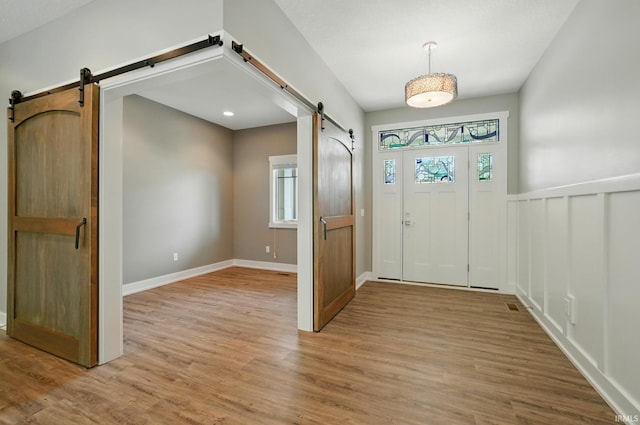 126 Tumbling Stone Ct, Fort Wayne, IN 46845 - entrance foyer featuring a barn door and light wood finished floors