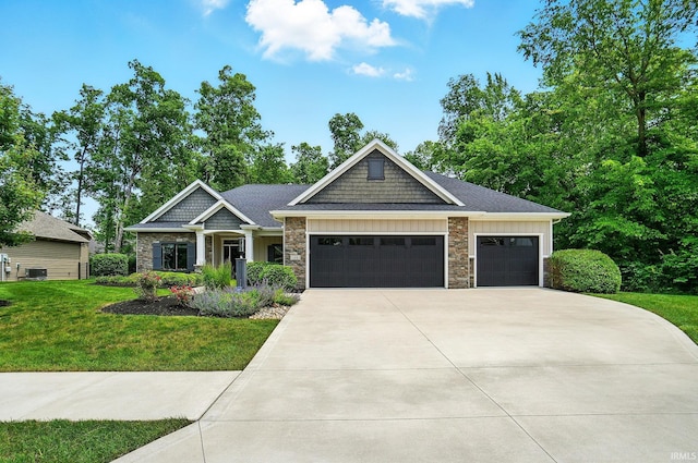 126 Tumbling Stone Ct, Fort Wayne, IN 46845 - craftsman-style home featuring a garage, concrete driveway, a front lawn, and stone siding