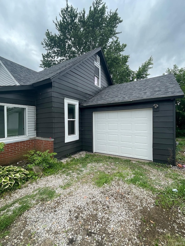 310 S Jefferson St, Bicknell, IN 47512 - view of home's exterior featuring driveway, a shingled roof, and a garage