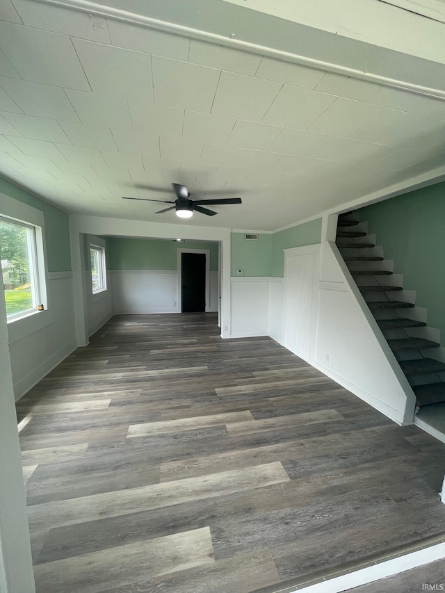 310 S Jefferson St, Bicknell, IN 47512 - unfurnished living room with wood finished floors, stairway, wainscoting, and ceiling fan