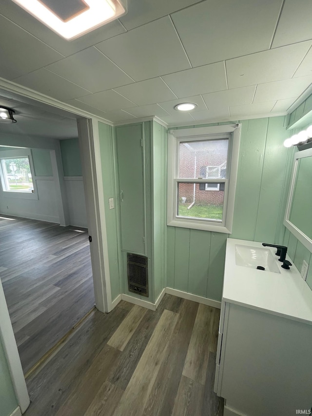 310 S Jefferson St, Bicknell, IN 47512 - bathroom with heating unit, vanity, and wood finished floors