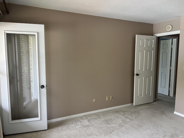 4501 N Wheeling Ave, Muncie, IN 47304 - unfurnished bedroom featuring carpet flooring, multiple windows, and a textured ceiling