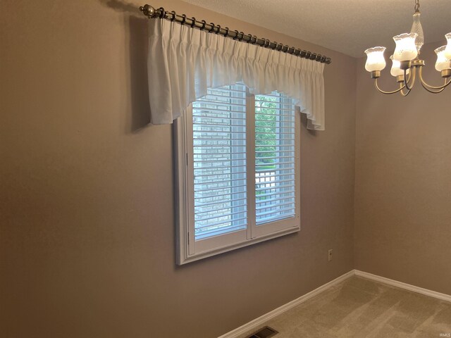 4501 N Wheeling Ave, Muncie, IN 47304 - carpeted empty room featuring a chandelier and baseboards