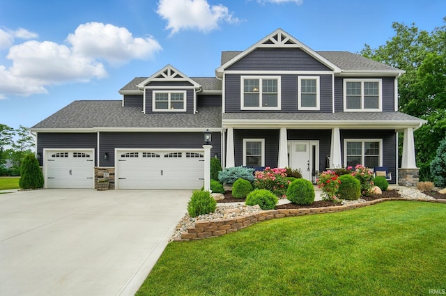 907 Switchfoot Dr, Huntertown, IN 46748 - craftsman inspired home featuring driveway, a front lawn, an attached garage, stone siding, and covered porch