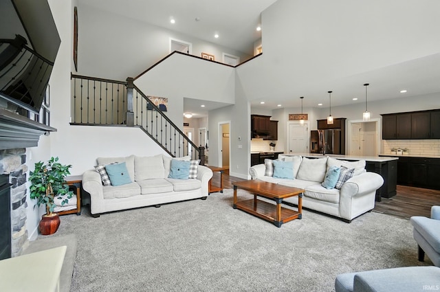 907 Switchfoot Dr, Huntertown, IN 46748 - living area with stairs, recessed lighting, wood finished floors, and a fireplace