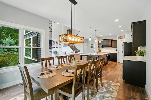 907 Switchfoot Dr, Huntertown, IN 46748 - dining area featuring stairs, wood finished floors, and recessed lighting