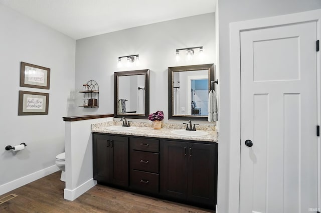 907 Switchfoot Dr, Huntertown, IN 46748 - bathroom featuring double vanity and wood finished floors