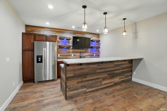907 Switchfoot Dr, Huntertown, IN 46748 - bar area with stainless steel fridge with ice dispenser, recessed lighting, wood finished floors, and pendant lighting