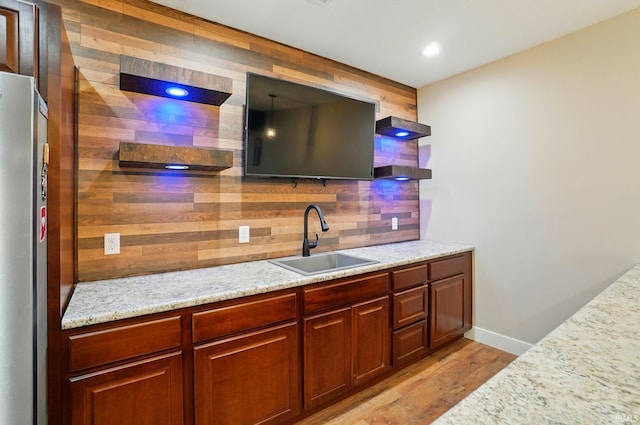 907 Switchfoot Dr, Huntertown, IN 46748 - bar featuring wood walls, light wood-type flooring, and freestanding refrigerator