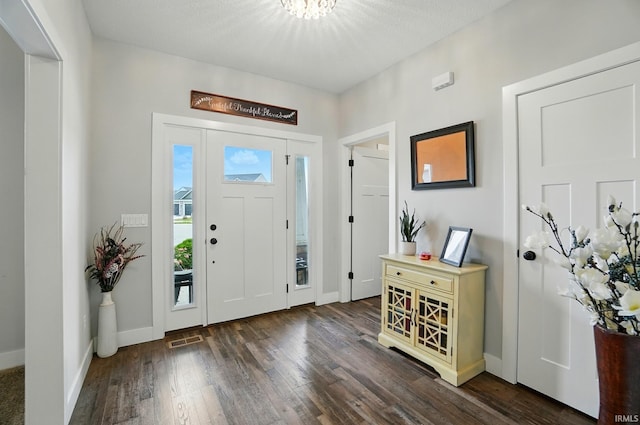 907 Switchfoot Dr, Huntertown, IN 46748 - foyer entrance featuring dark wood finished floors and a chandelier