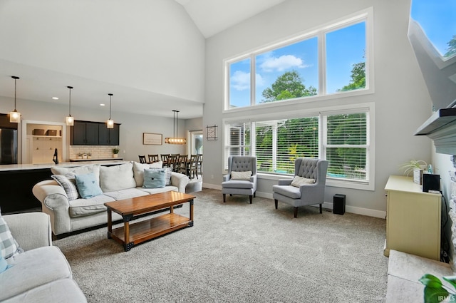907 Switchfoot Dr, Huntertown, IN 46748 - living area with high vaulted ceiling, healthy amount of natural light, light carpet, and a fireplace