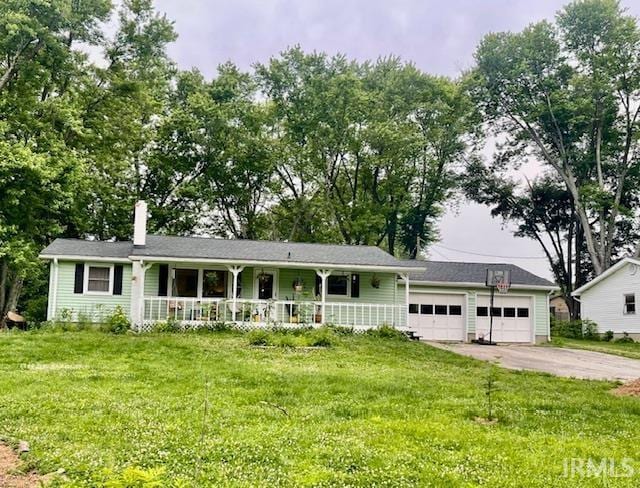 7210 W Dinsmore Rd, Bloomington, IN 47403 - single story home with covered porch, a chimney, a front yard, and a garage