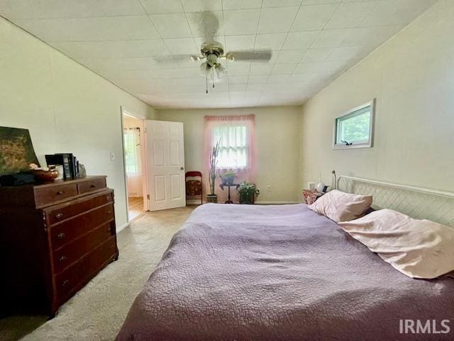 7210 W Dinsmore Rd, Bloomington, IN 47403 - carpeted bedroom featuring multiple windows and ceiling fan