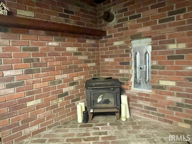 7210 W Dinsmore Rd, Bloomington, IN 47403 - detailed view of a wood stove and brick wall