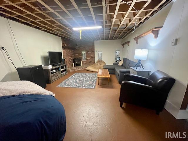 7210 W Dinsmore Rd, Bloomington, IN 47403 - living area featuring a brick fireplace and brick wall
