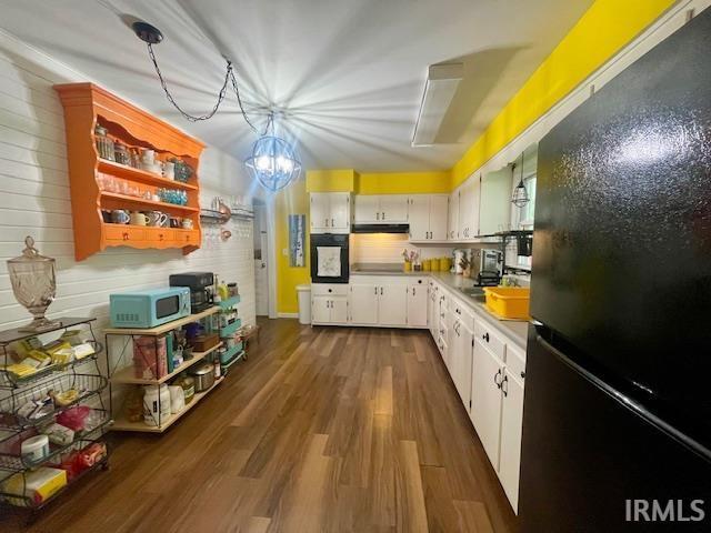7210 W Dinsmore Rd, Bloomington, IN 47403 - kitchen featuring black appliances, light countertops, under cabinet range hood, white cabinetry, and dark wood-style floors