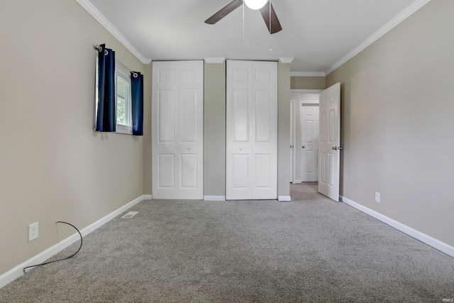 867 Park Plaza Dr, Evansville, IN 47715 - unfurnished bedroom featuring ornamental molding, carpet floors, two closets, and ceiling fan