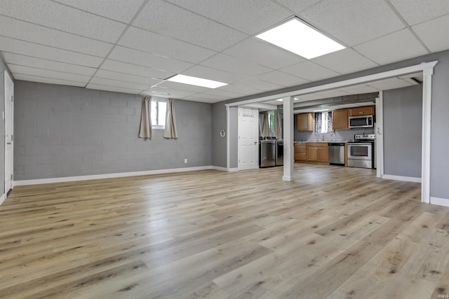867 Park Plaza Dr, Evansville, IN 47715 - unfurnished living room with light wood-style flooring, a drop ceiling, and concrete block wall