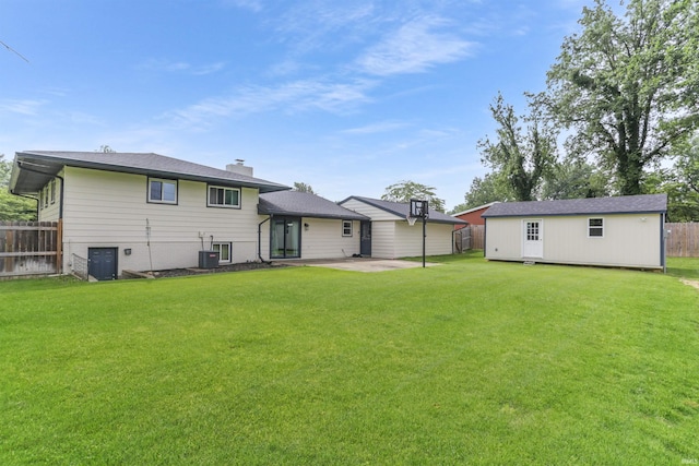 867 Park Plaza Dr, Evansville, IN 47715 - rear view of property with a patio, a chimney, and an outbuilding