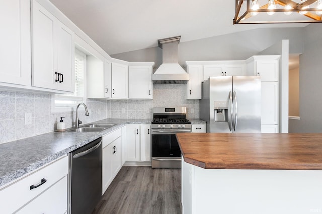 509 Janewood Ct, Goshen, IN 46526 - kitchen featuring appliances with stainless steel finishes, premium range hood, wood counters, vaulted ceiling, and white cabinetry