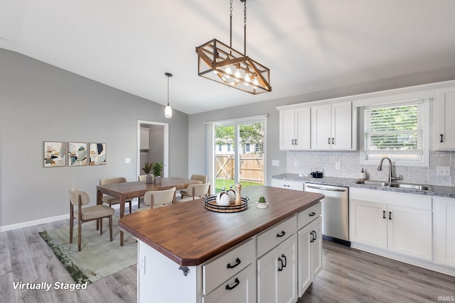 509 Janewood Ct, Goshen, IN 46526 - kitchen with dishwasher, butcher block countertops, vaulted ceiling, light wood finished floors, and backsplash