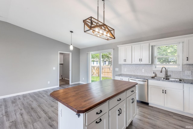 509 Janewood Ct, Goshen, IN 46526 - kitchen with stainless steel dishwasher, lofted ceiling, wooden counters, decorative backsplash, and light wood finished floors