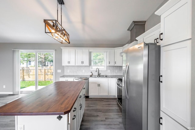 509 Janewood Ct, Goshen, IN 46526 - kitchen with stainless steel appliances, wood counters, a center island, dark wood-style flooring, and tasteful backsplash
