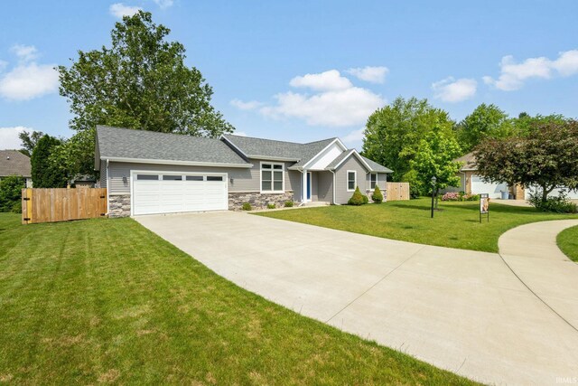 509 Janewood Ct, Goshen, IN 46526 - view of front of home featuring driveway, stone siding, and an attached garage