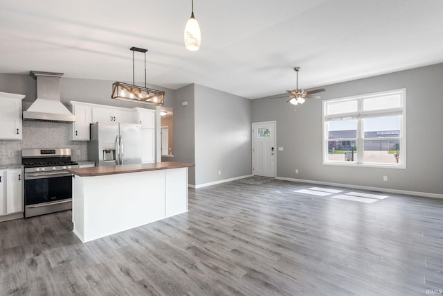 509 Janewood Ct, Goshen, IN 46526 - kitchen featuring custom exhaust hood, stainless steel appliances, butcher block counters, tasteful backsplash, and white cabinetry