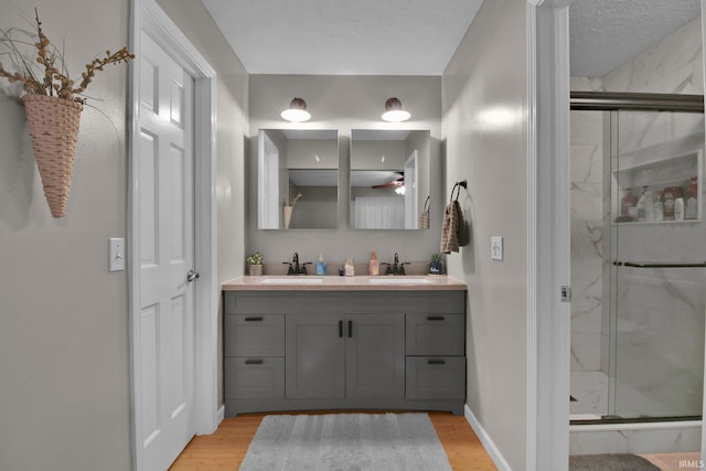 207 Meadows Dr, Greentown, IN 46936 - full bath with double vanity, a marble finish shower, and wood finished floors