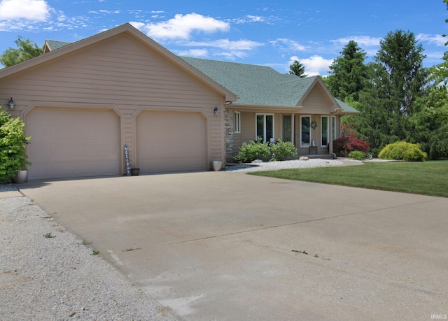 207 Meadows Dr, Greentown, IN 46936 - view of front of property with a garage, concrete driveway, roof with shingles, and a front yard