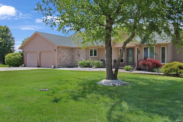 207 Meadows Dr, Greentown, IN 46936 - ranch-style house with an attached garage, a front yard, and concrete driveway