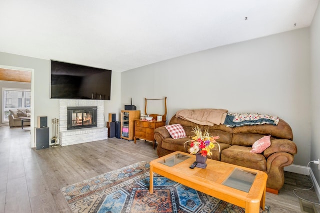 1006 Heather Rdg, Angola, IN 46703 - living area featuring wood finished floors and a brick fireplace