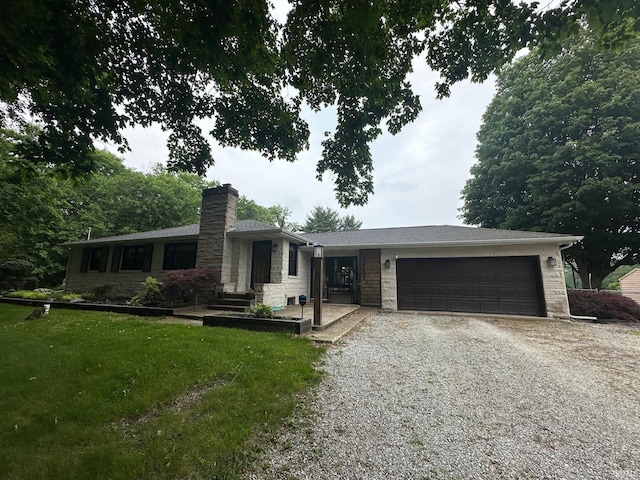 32131 State Road 2nd Rd, New Carlisle, IN 46552 - ranch-style home with gravel driveway, stone siding, an attached garage, a chimney, and a front lawn