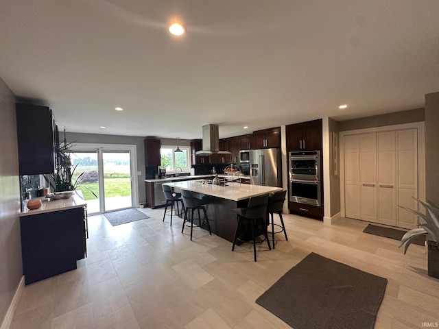 32131 State Road 2nd Rd, New Carlisle, IN 46552 - kitchen featuring island exhaust hood, a kitchen bar, stainless steel appliances, light countertops, and dark brown cabinetry
