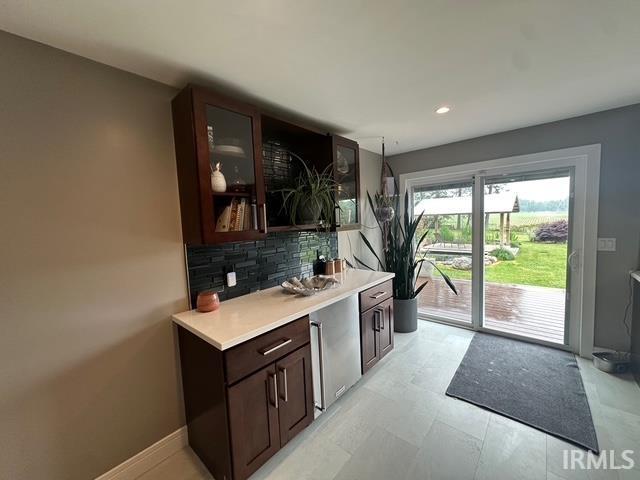 32131 State Road 2nd Rd, New Carlisle, IN 46552 - kitchen with tasteful backsplash, light countertops, dark brown cabinets, glass insert cabinets, and recessed lighting