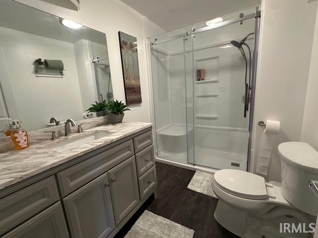 32131 State Road 2nd Rd, New Carlisle, IN 46552 - full bath with vanity, a stall shower, and wood finished floors